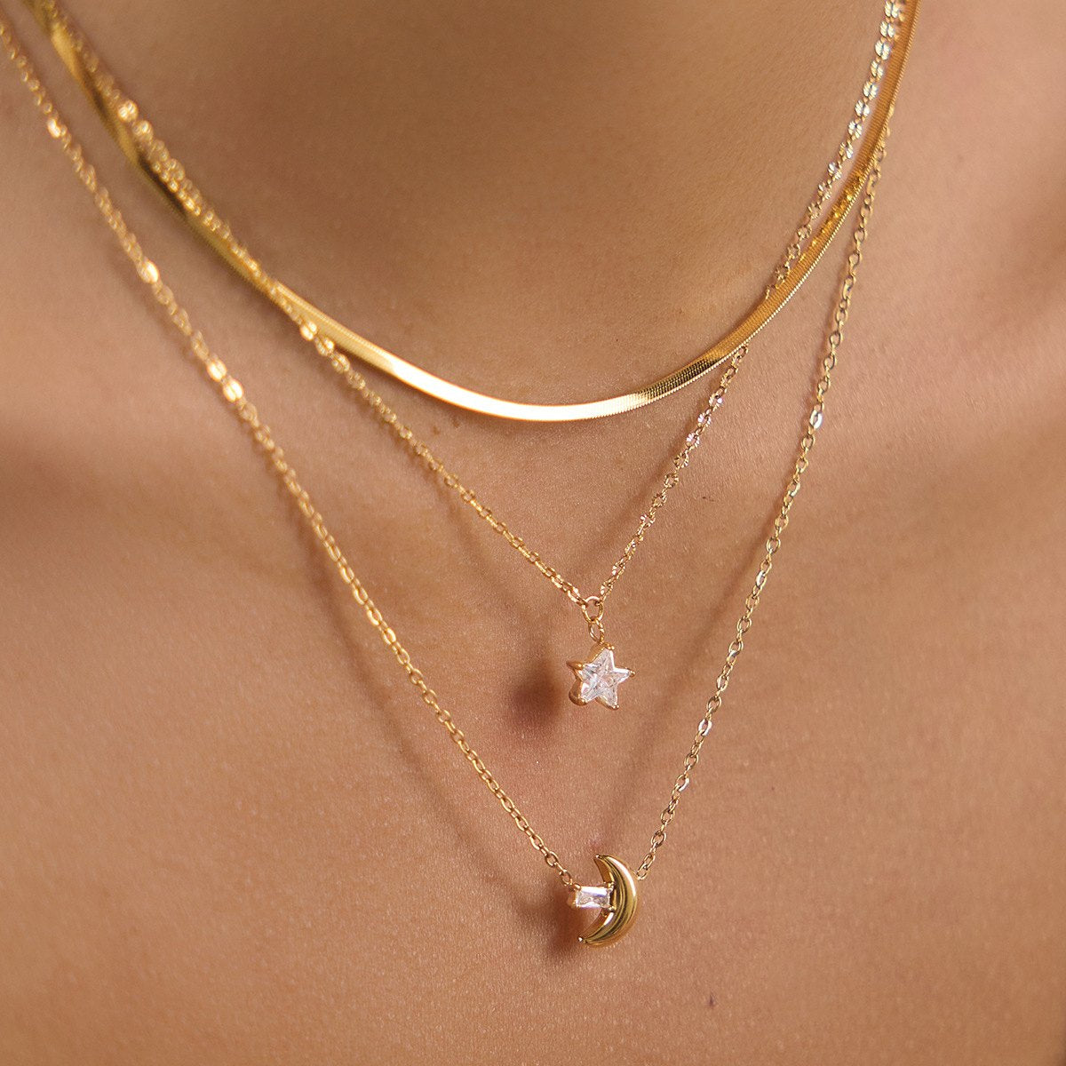 Woman wearing layered gold-plated Luli necklaces